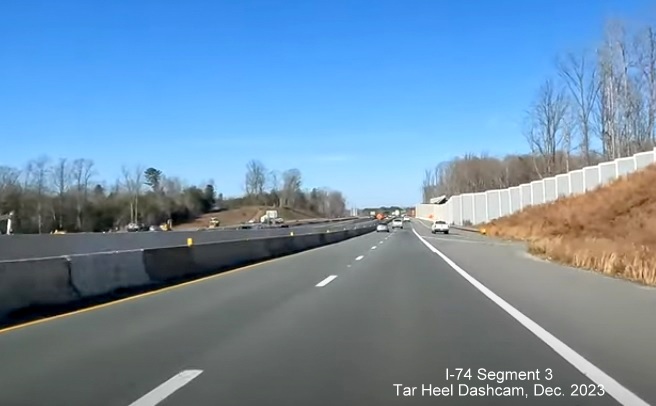 Image of driving completed lanes for US 52 North (Future I-74 West) after NC 65 exit, left lane 
       currently closed due to being used for US 52 South traffic in the distance, Tar Heel Dashcam, December 2023