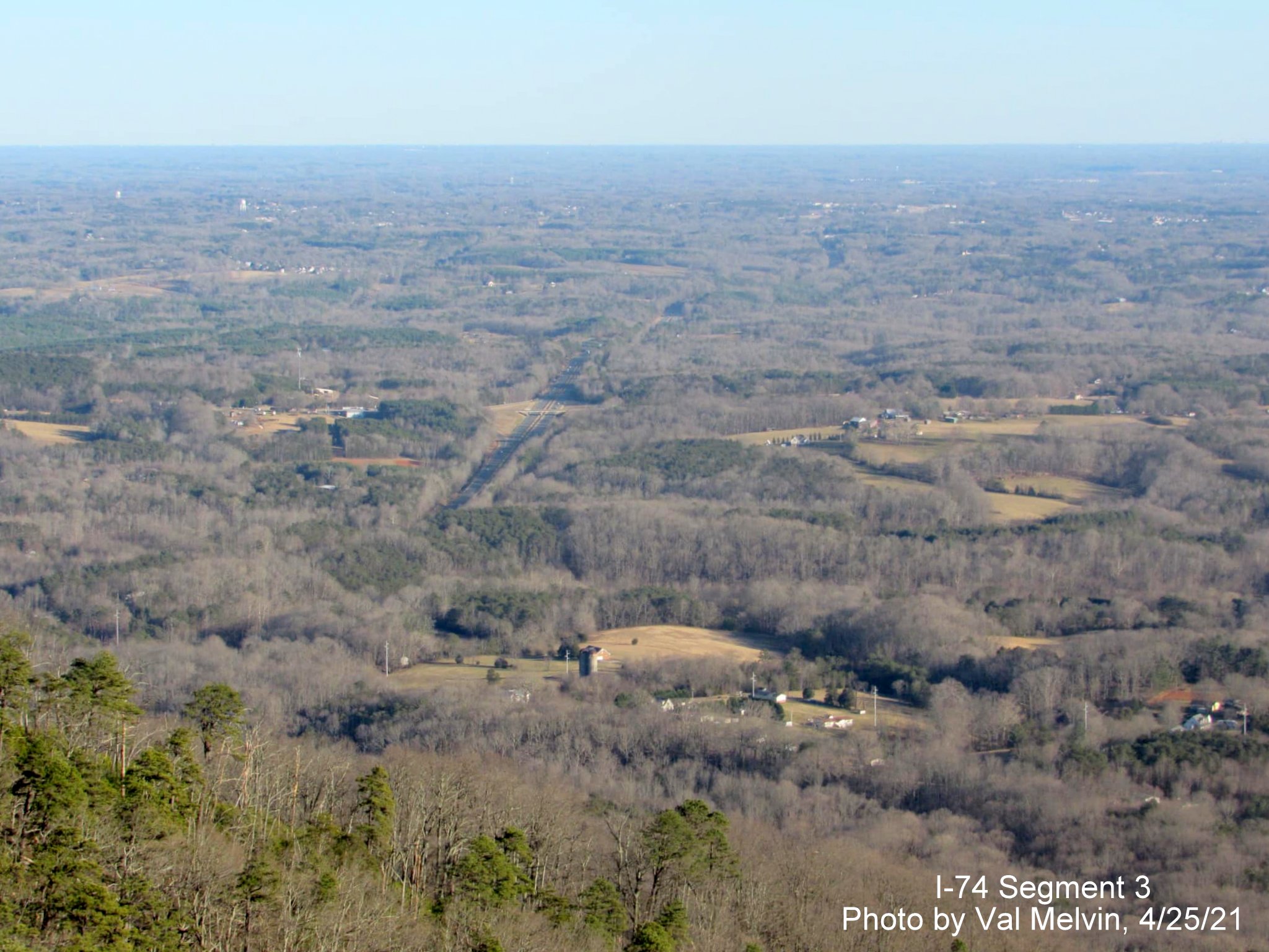 View from Pilot Mountain of US 52 (Future I-74) freeway 
	  heading southeast toward Winston-Salem, by Val Melvin, April 2021