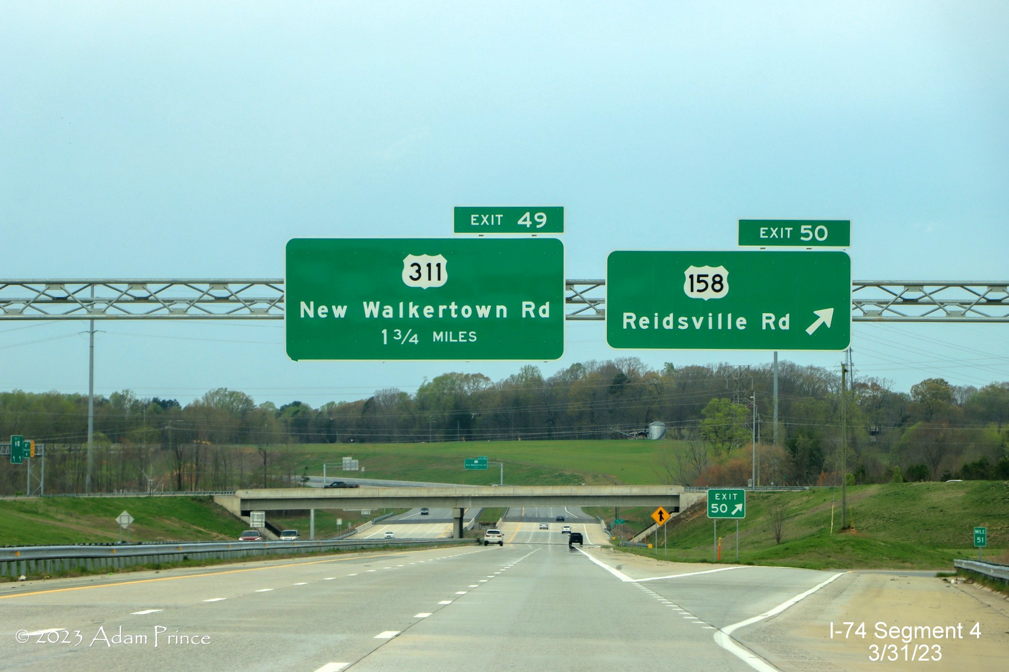Image of overhead signage at the ramp for the US 158 exit on NC 74 (Future I-74) West/Winston-Salem 
        Northern Beltway, Adam Prince, March 2023