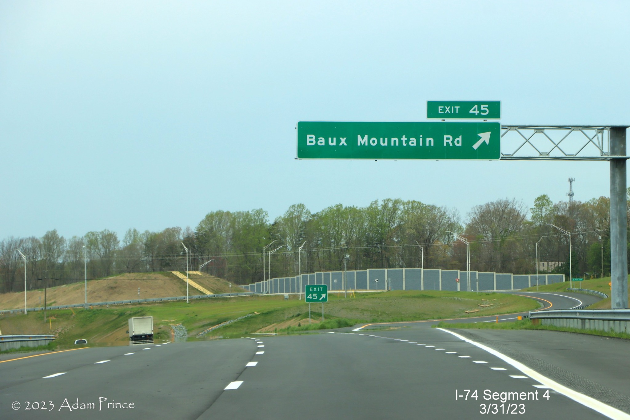 Image of overhead ramp sign for Baux Mountain Road exit on NC 74 (Future I-74) West/Winston-Salem 
        Northern Beltway, Adam Prince, March 2023