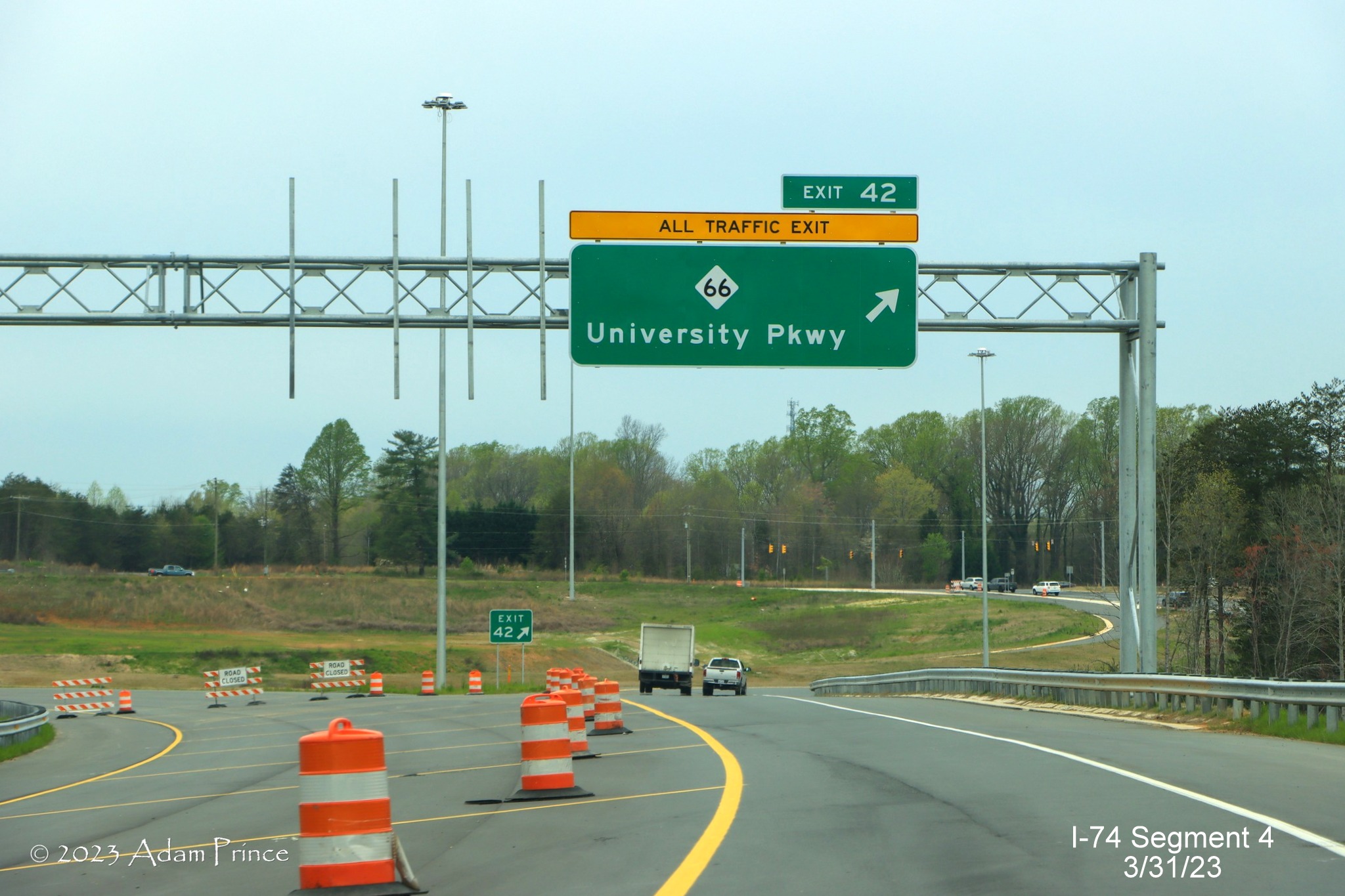 Image of overhead signage at the current end of NC 74 (Future I-74) West/Winston-Salem 
        Northern Beltway at NC 66, Adam Prince, March 2023