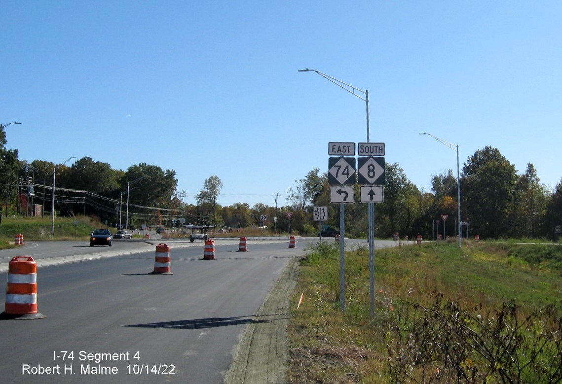 Image of uncovered NC 74 and NC 8 trailblazers approaching roundabout at future NC 74 East ramp 
                                             in Winston-Salem, October 2022