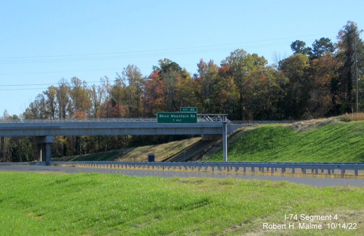 Image of 1 mile advance overhead sign for Baux Mountain Road exit placed on unopened NC 74 
        (Future I-74) Winston-Salem Northern Beltway near Old Hollow Road bridge in Forsyth County, October 2022