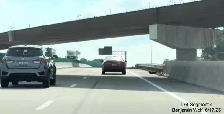 Image of traffic on I-40 East passing under the last flyover ramp and over the future
	   I-74 / Winston-Salem Northern Beltway lanes, screen grab from Benjamin Wolf video, June 2025