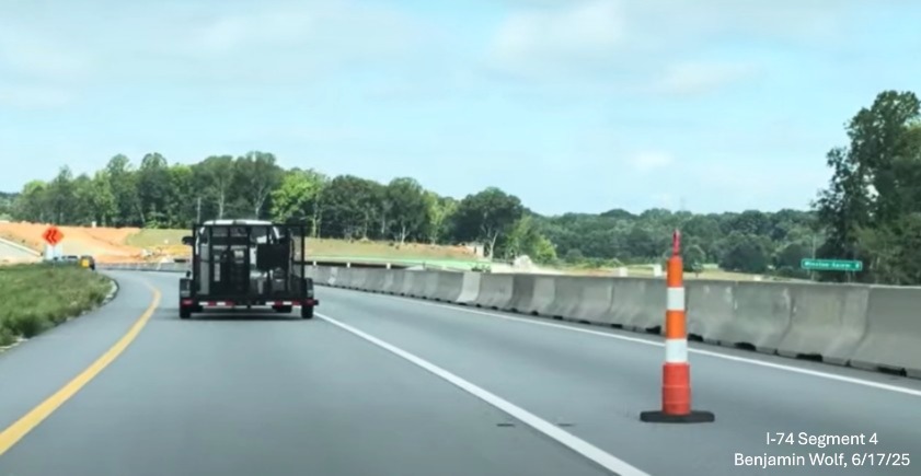 Image of traffic on I-74 West passing the future off-ramp to
	  the NC 192 in the Winston-Salem Northern Beltway interchange work zone, screen grab from Benjamin Wolf video, June 2025