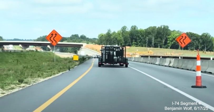 Image of traffic on I-74 West passing the future NC 192 ramp that will travel over
	  the I-74 West lanes at the start of the Winston-Salem Northern Beltway, screen grab from Benjamin Wolf video, June 2025