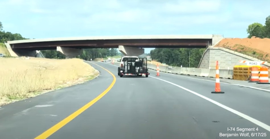 Image of traffic on I-74 West heading towards the future off-ramp from NC 192
	  East to the Winston-Salem Northern Beltway, screen grab from Benjamin Wolf video, June 2025