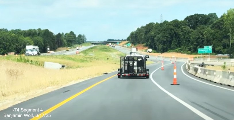 Image of traffic on temporary I-74 East lanes rejoining the permanent lanes after
	  the future Winston-Salem Northern Beltway interchange, screen grab from Benjamin Wolf video, June 2025