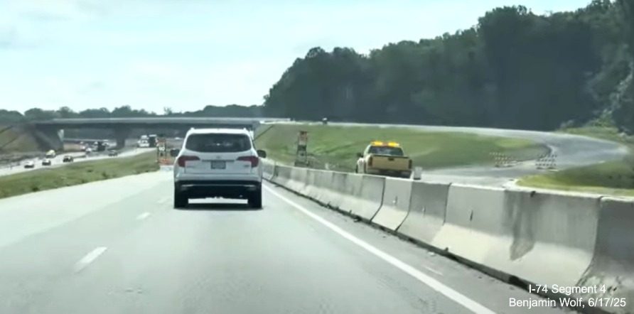 Image of traffic on I-74 East passing the future off-ramp to I-74 West /
	  Winston-Salem Northern Beltway, screen grab from Benjamin Wolf video, June 2025