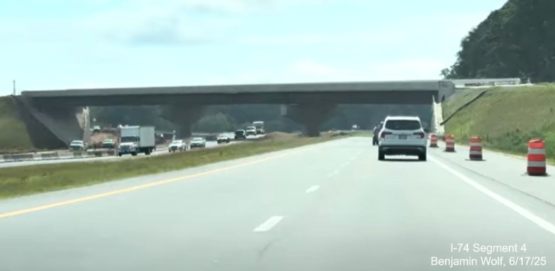 Image of traffic on I-74 East heading under the future off-ramp to I-74 West /
	  Winston-Salem Northern Beltway, screen grab from Benjamin Wolf video, June 2025