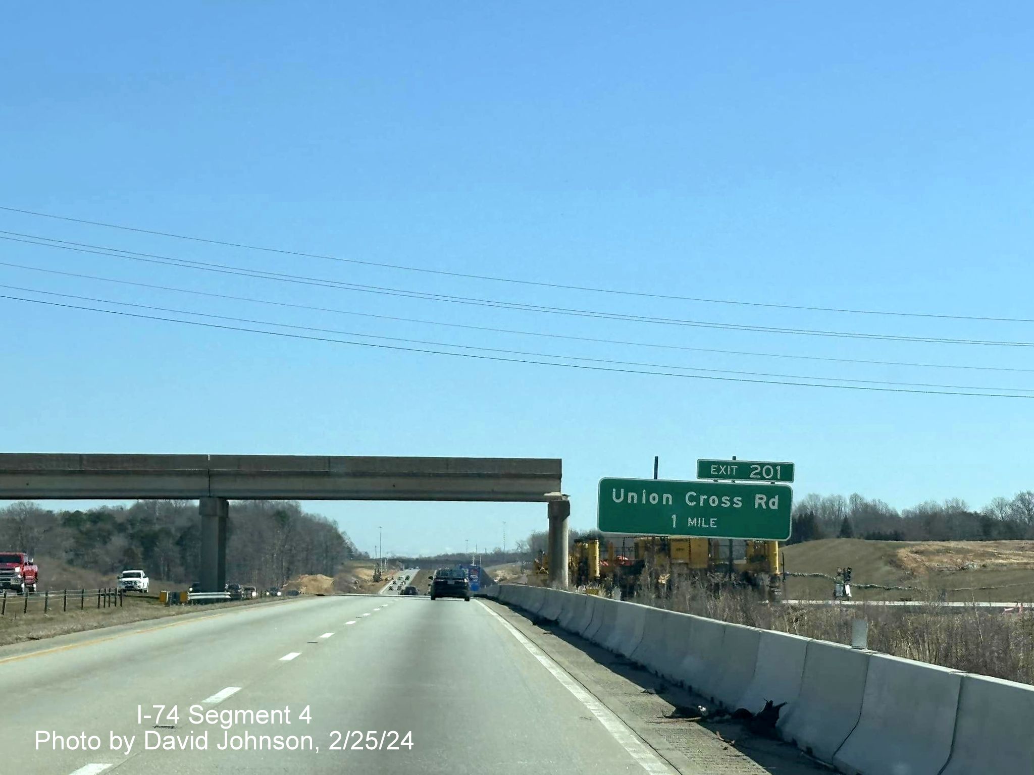 Image of still to be demolished bridge over I-40 East with future I-74/Winston-Salem 
        Northern Beltway west ramps in the distance in Forsyth County, by David Johnson, February 2024