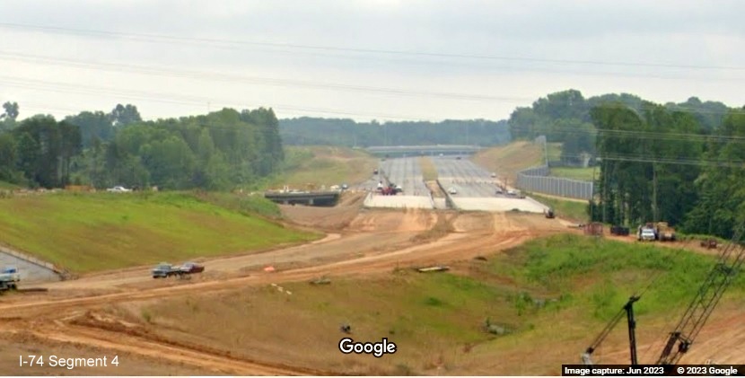 Image from US 52 North roadway looking east along future path of I-74 to NC 66 bridge, being built
        as part of the future Winston-Salem Northern Beltway interchange, Google Maps Street View, June 2023