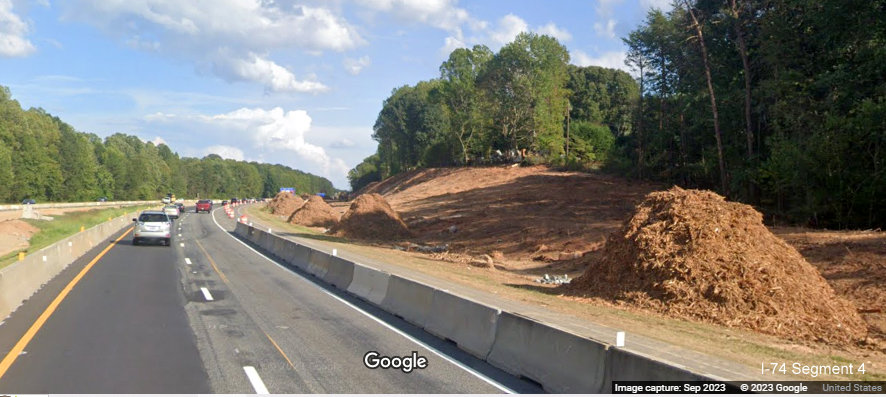 View of piles of excavated materials along I-74 East lanes in Winston-Salem Northern Beltway 
       interchange work zone, Google Maps Street View, September 2023