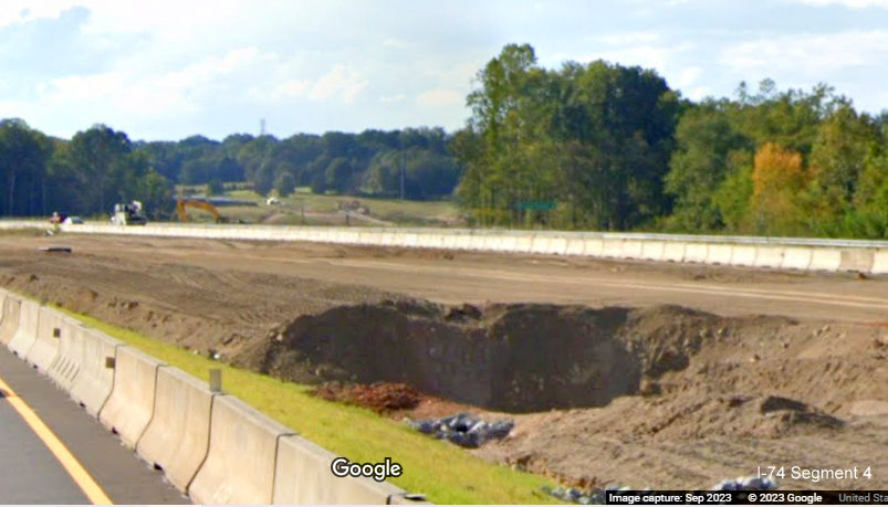View across I-74 lanes toward future Winston-Salem Northern Beltway 
      lanes, Google Maps Street View, September 2023