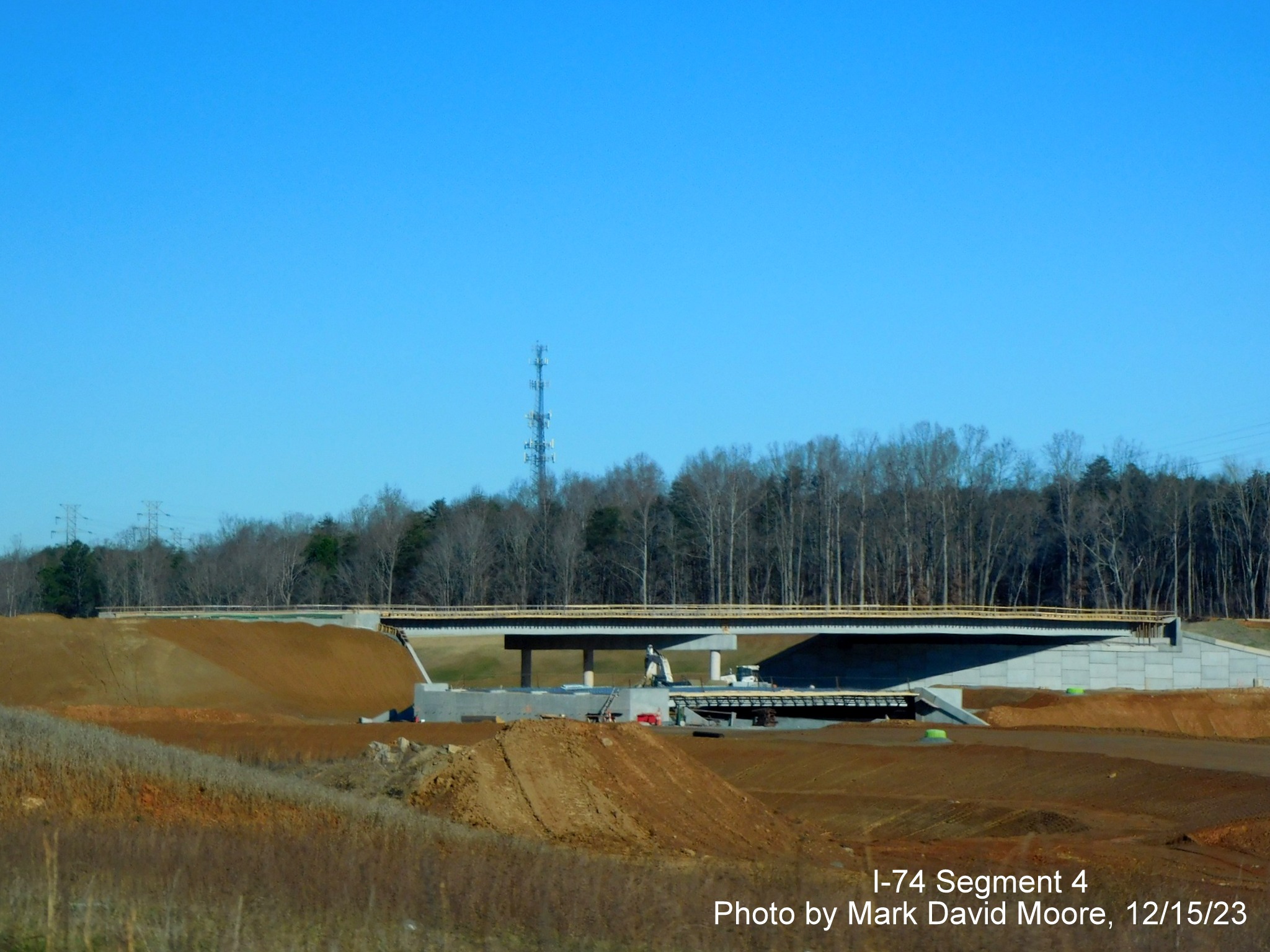 Image from US 52 North of future ramp construction from NC 74 West to US 52 South and work
        on the future NC 74 East roadway, by Mark David Moore, December 2023