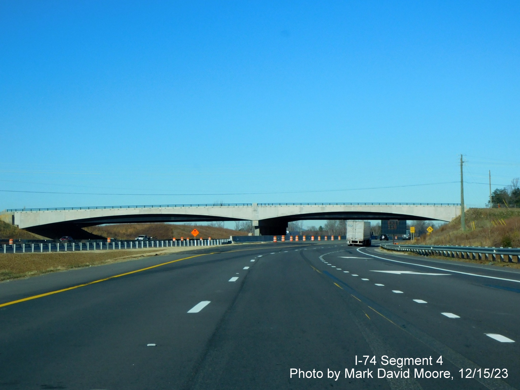 Image of US 52 North approaching the current ramp from NC 74 West/Winston-Salem Northern
      Beltway with future I-74 West roadway on the left, by Mark David Moore, December 2023