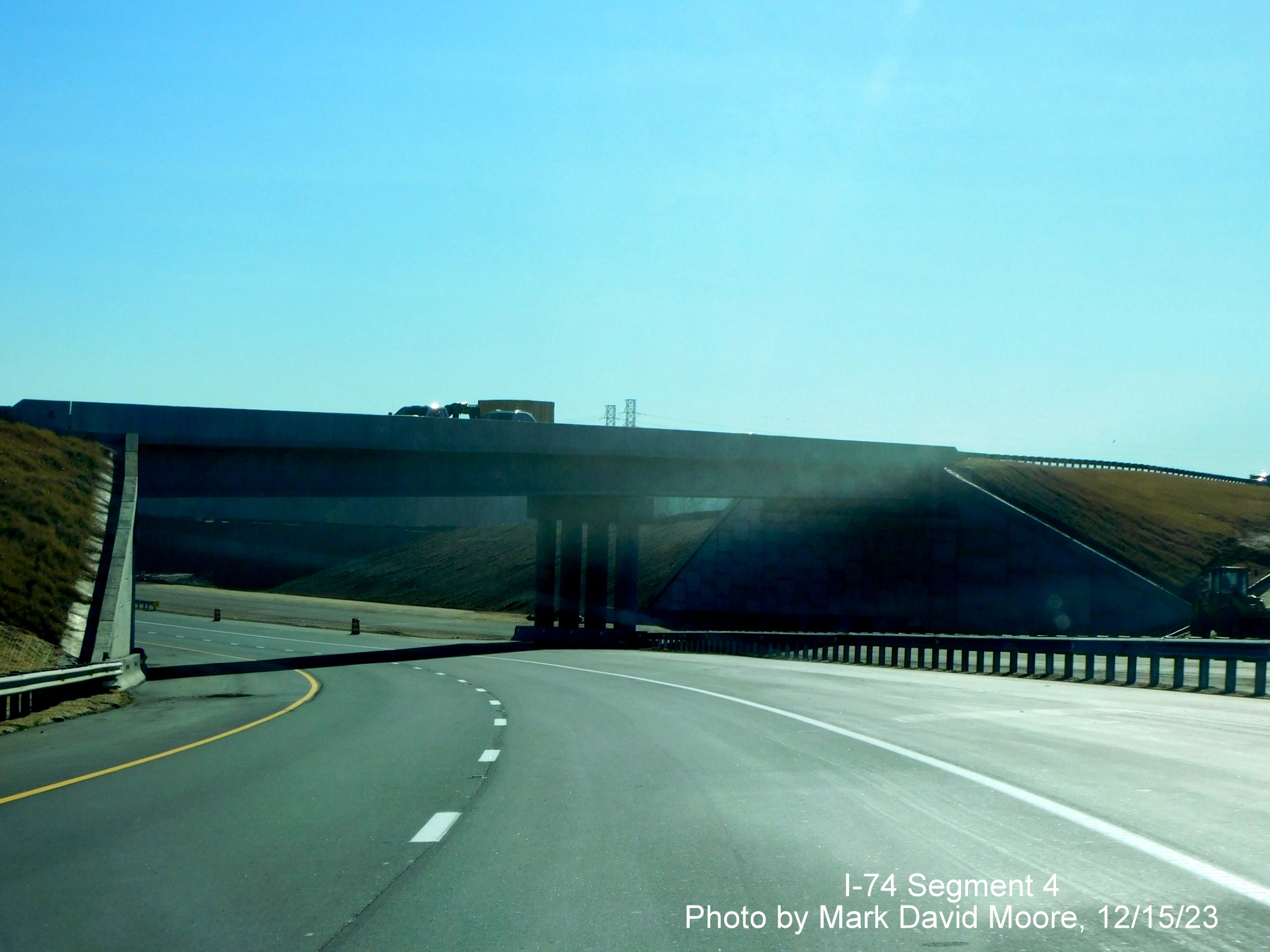 Image of NC 74 East/Winston-Salem Northern approaching the US 52 North bridge temporarily using
      the future westbound roadway, by Mark David Moore, December 2023