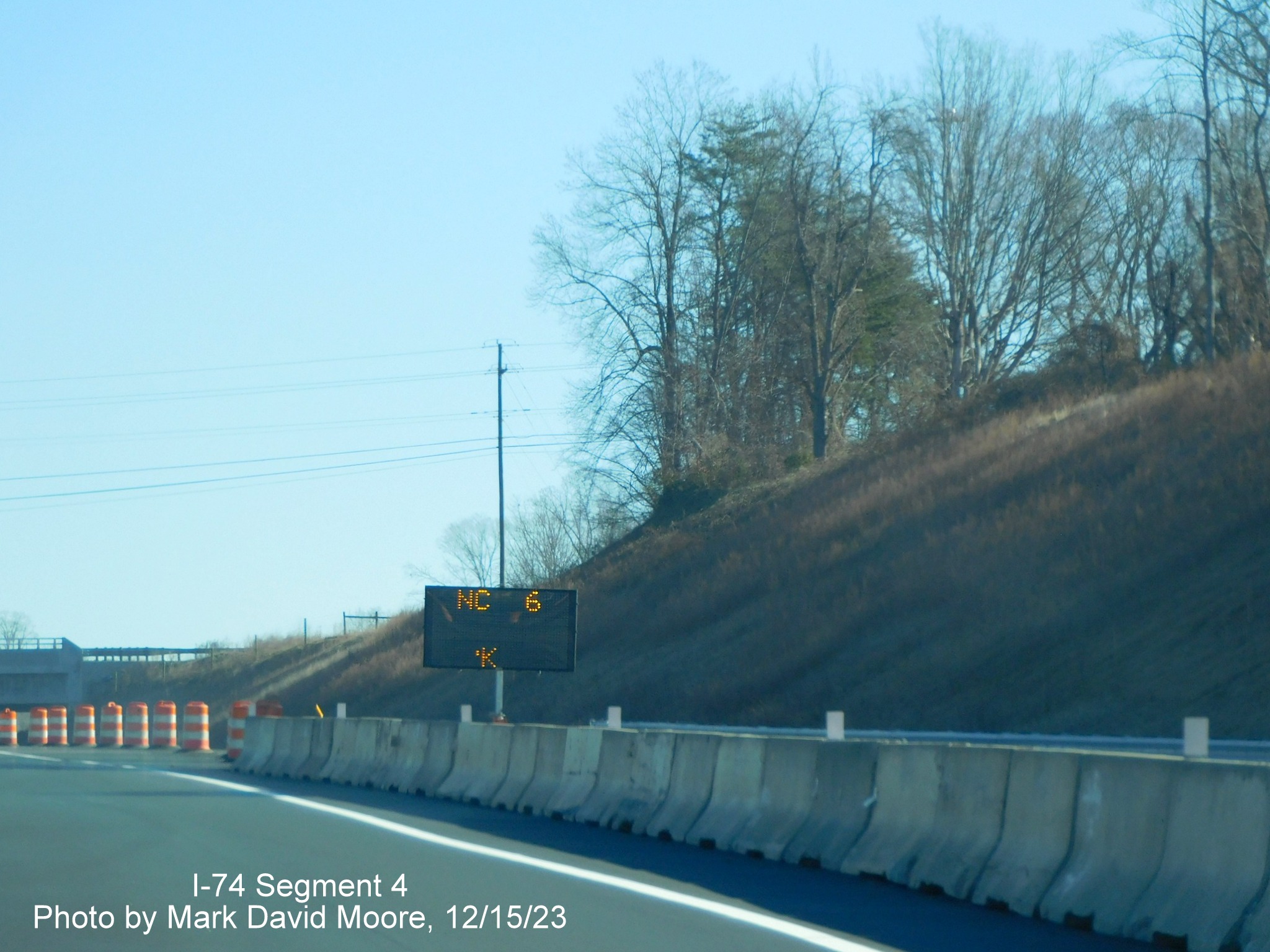 Image of VMS being used as temporary ramp sign for NC 66/University Parkway exit on NC 74 (Future I-74) 
        East after segment from US 52 South opened, from video by Tar Heel Dashcam, December 2023
