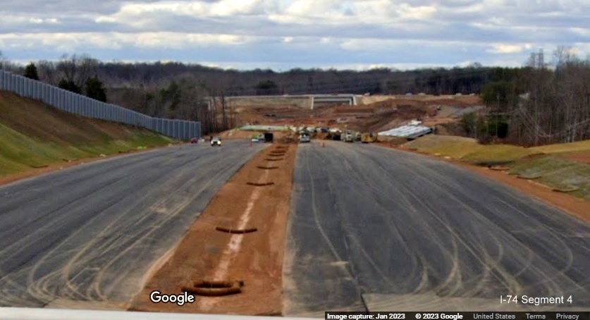 Image of view west from NC 66/University Parkway bridge toward future Winston-Salem Northern Beltway 
        exit with US 52, Google Maps Street View, January 2023