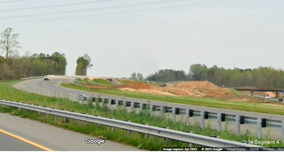 Image of future US 52 North lanes near completion curving toward bridge over future Northern Beltway lanes, 
        Google Maps Street View image, April 2023