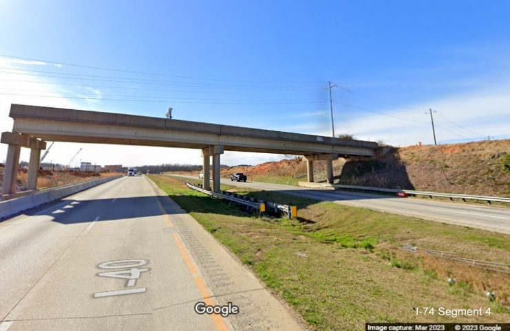Image of remaining old bridge being demolished to make way for wider I-40 lanes in I-74/
        Winston-Salem Northern Beltway construction zone along I-40 East, Google Maps Street View, March 2023