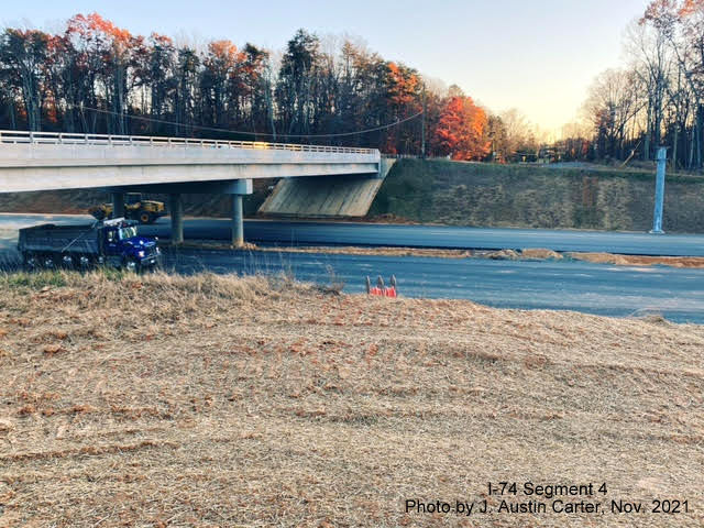 Image of open University Avenue bridge over future I-74/Winston Salem Northern Beltway looking south 
       from former roadway roadbed, by J. Austin Carter, November 2021