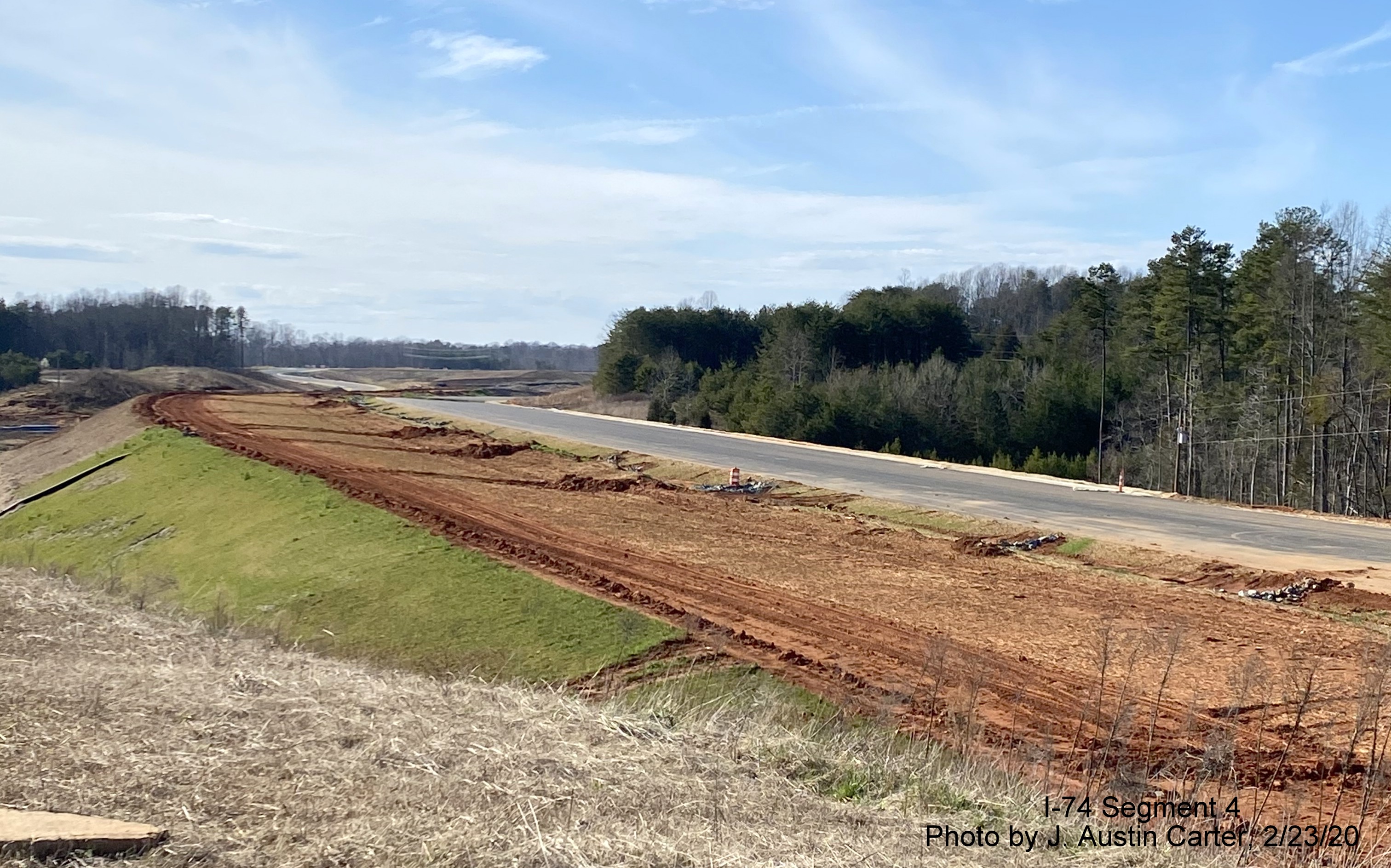 Image of road construction in vicinity of Dillon Farm Road looking west along roadbed of 
        future I-74/Winston-Salem Beltway toward US 311, by J. Austin Carter in Feb. 2020