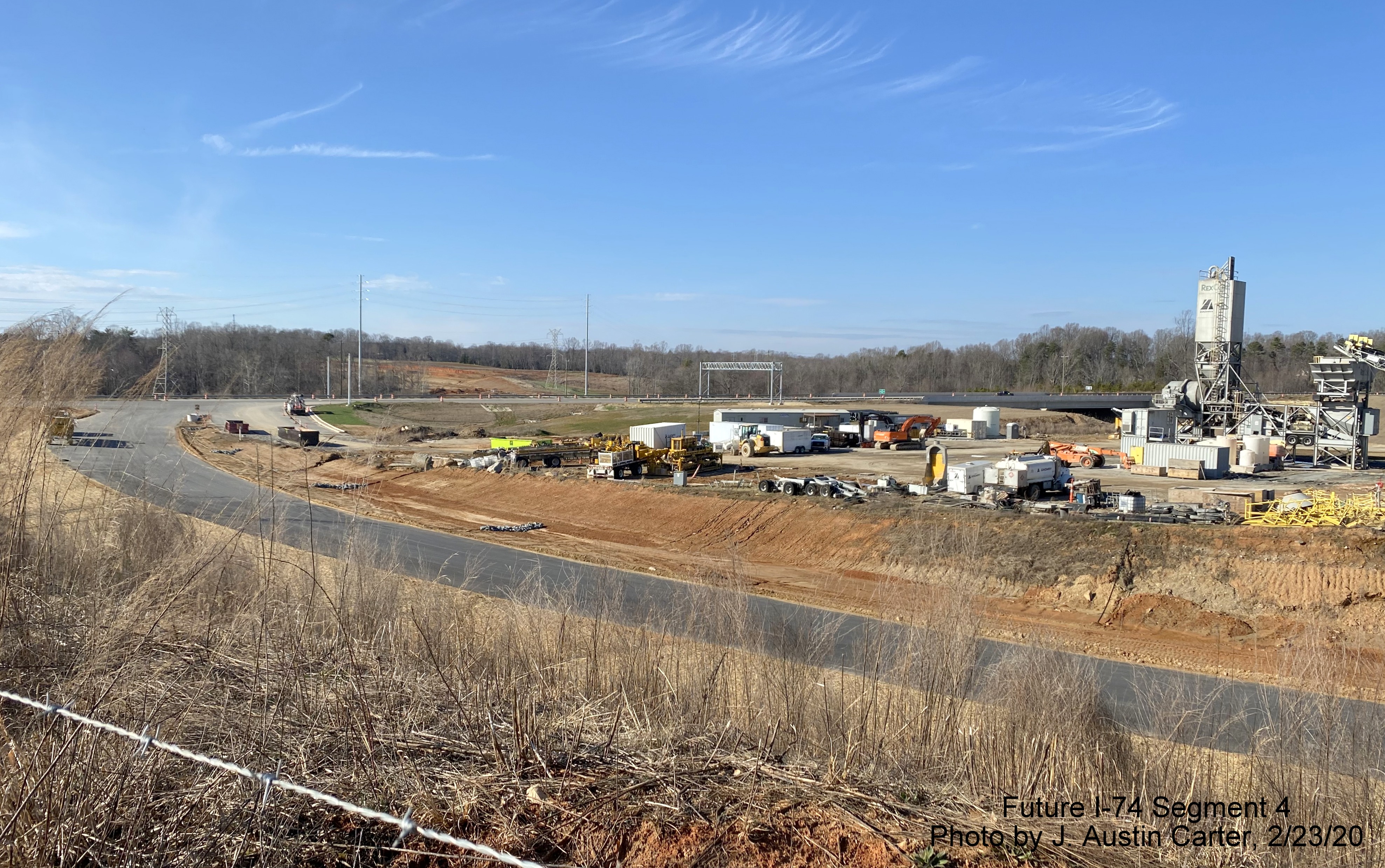 Image of on-ramp from US 158 to future I-74 East/Winston-Salem Beltway with temporary
        concrete plant in middle of interchange, by J. Austin Carter in Feb. 2020