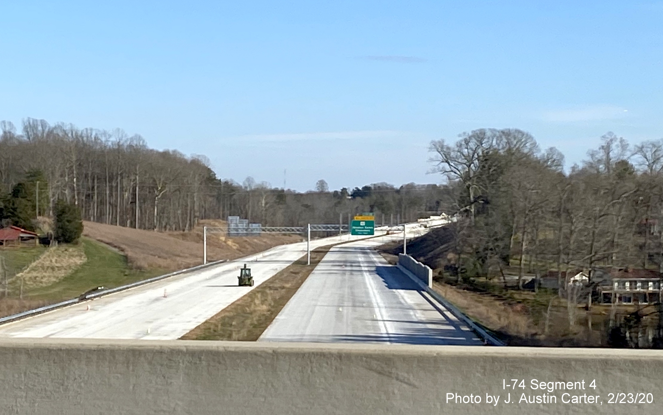 Image of new overhead signs being placed along future I-74/Winston-Salem Beltway for 
        US 421 and US 158 exits from Old Belews Creek Road bridge, by J. Austin Carter in Feb. 2020