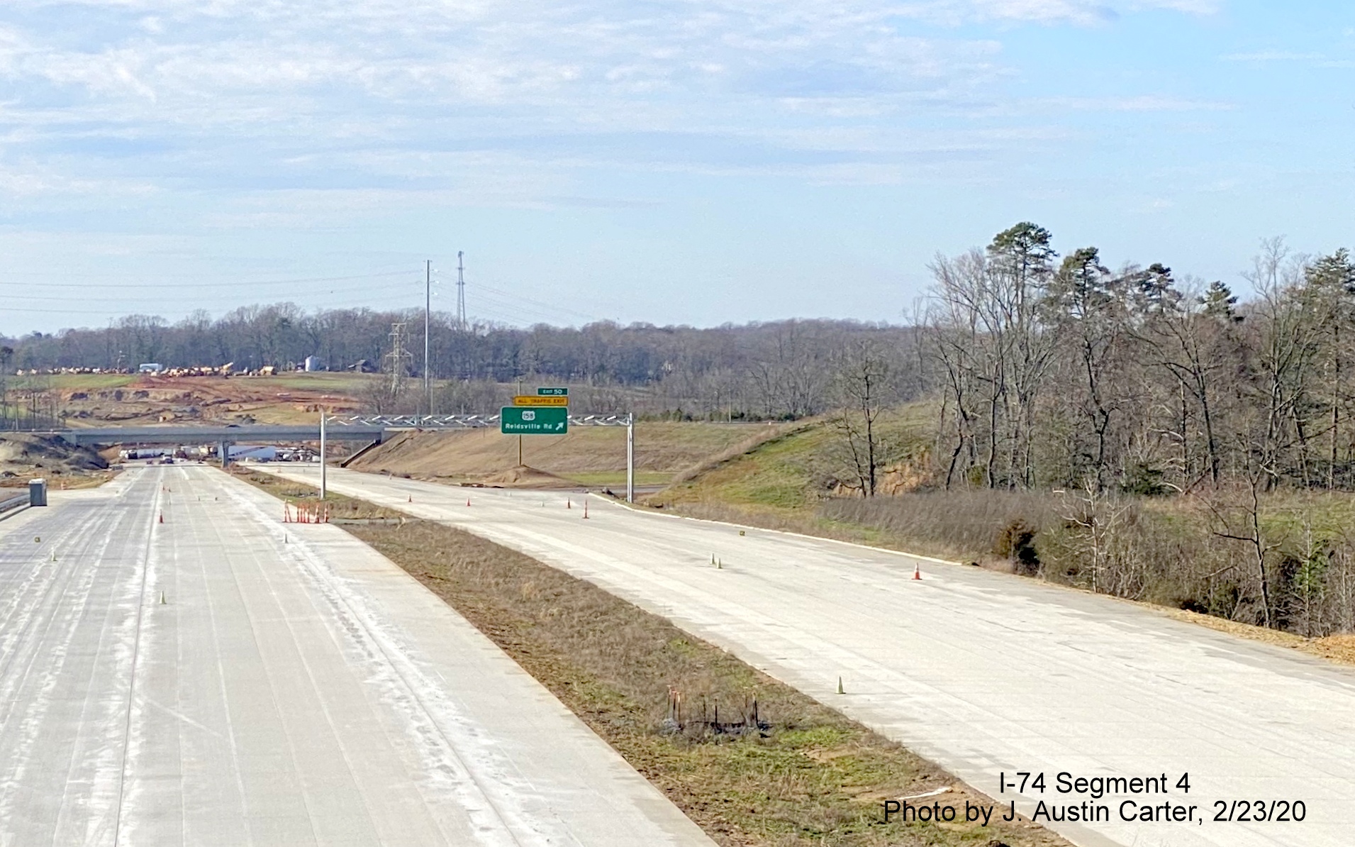 Image newly placed overhead exit ramp sign for US 158 on Future I-74 West/
        Winston-Salem Beltway, by J. Austin Carter in Feb. 2020