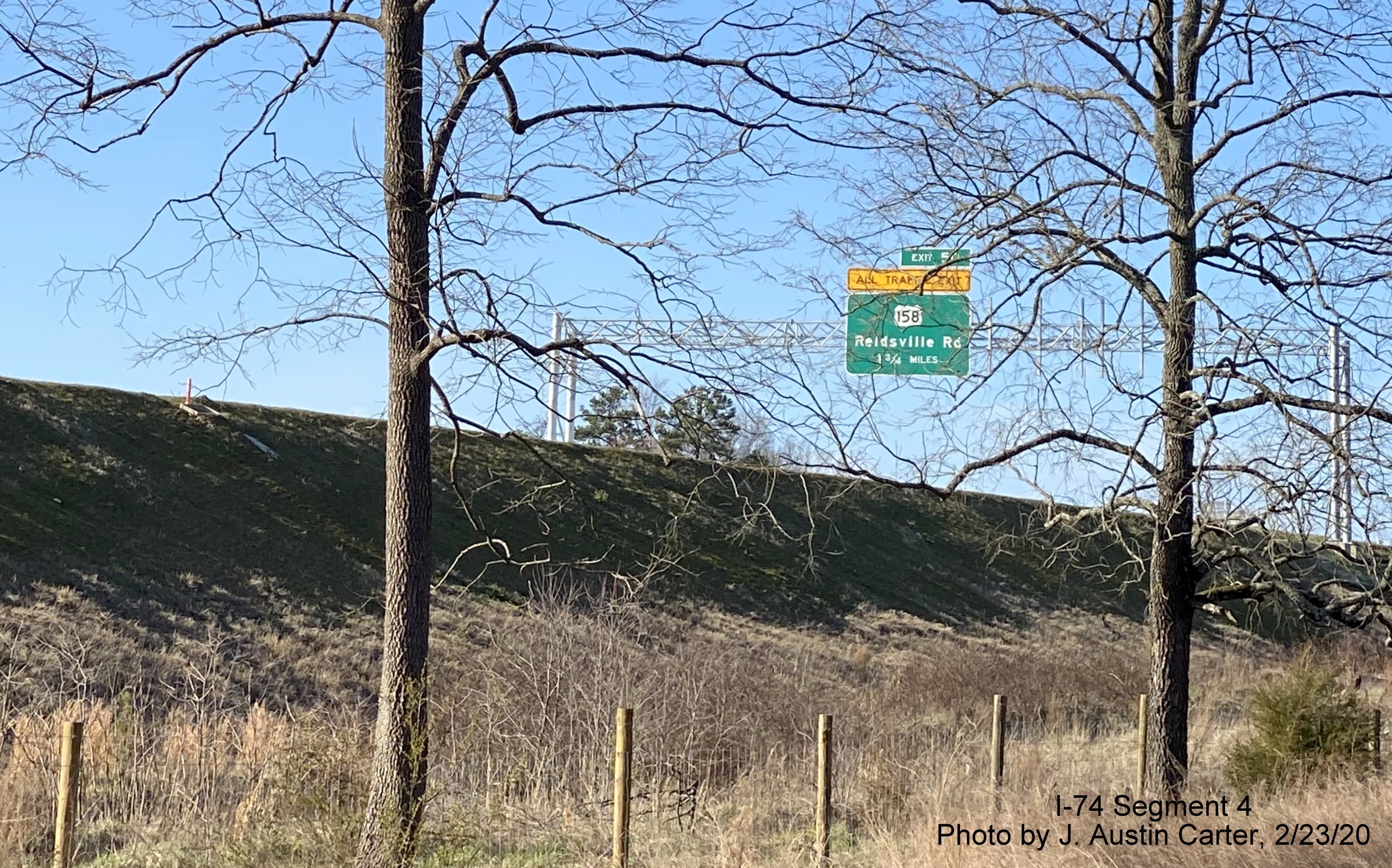Image of overhead signage for US 158 exit in vicinity of West Mountain Street bridge with Future 
        I-74/Winston-Salem Beltway, by J. Austin Carter in Feb. 2020