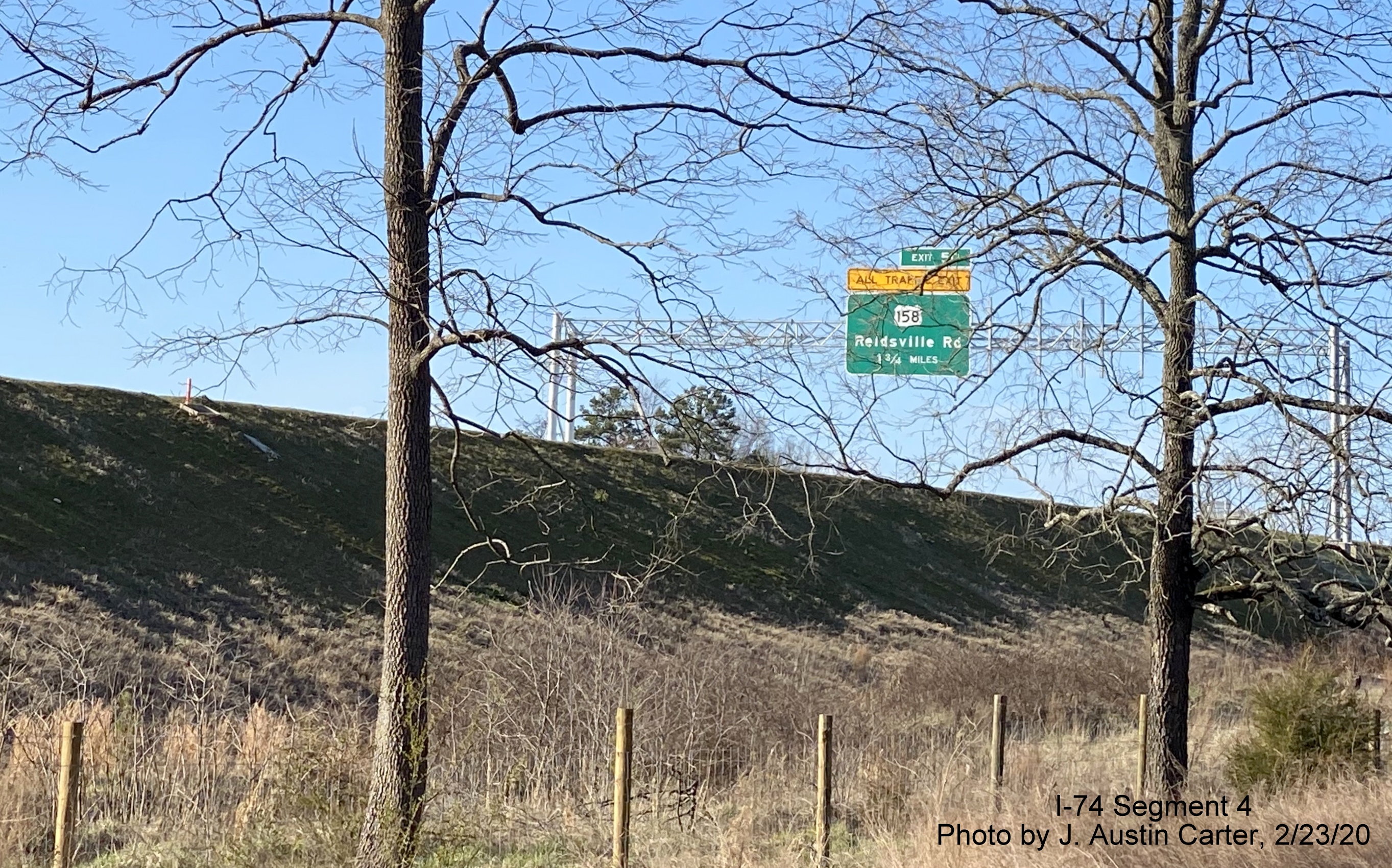 Image of overhead signage for US 158 exit in vicinity of West Mountain Street bridge with Future 
        I-74/Winston-Salem Beltway, by J. Austin Carter in Feb. 2020