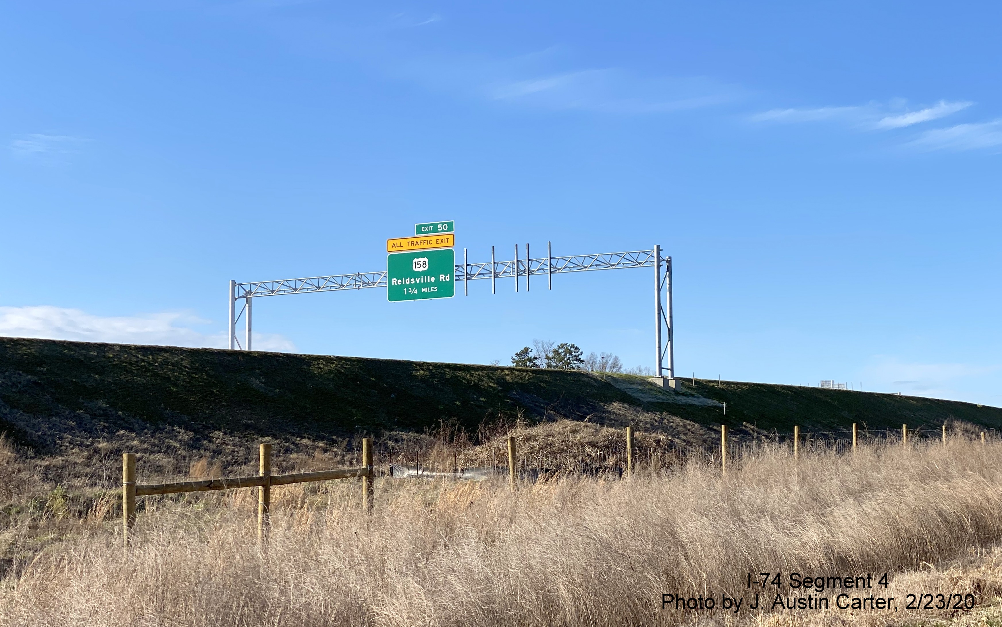 Image of overhead 1 1/4 mile advance sign for US 158 exit on Future I-74 West/
        Winston-Salem Beltway, by J. Austin Carter in Feb. 2020