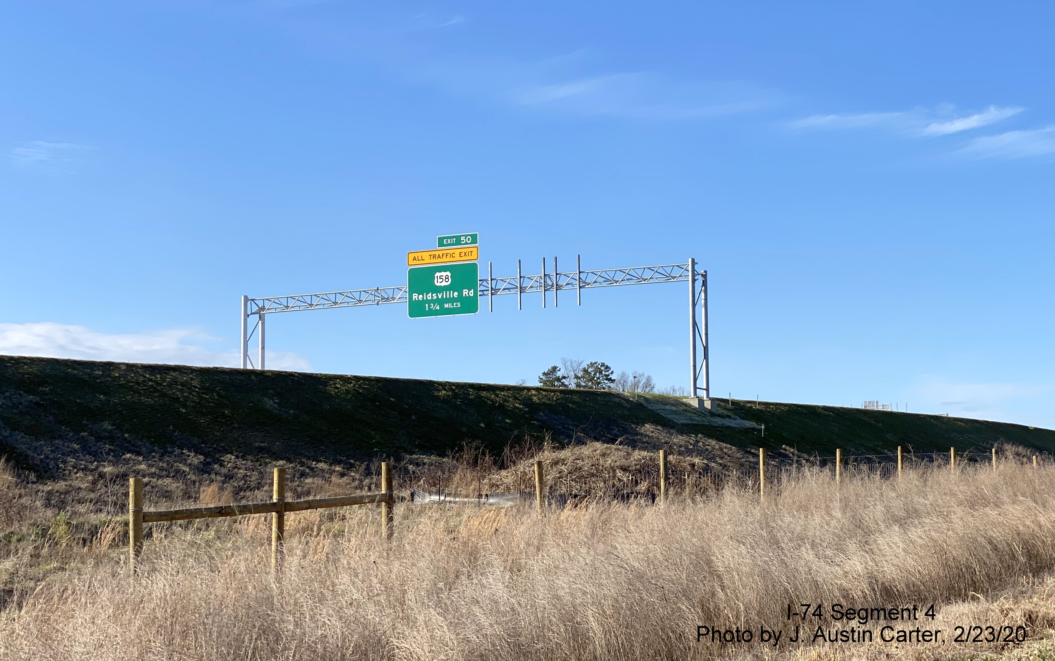 Image of overhead 1 1/4 mile advance sign for US 158 exit on Future I-74 West/
        Winston-Salem Beltway, by J. Austin Carter in Feb. 2020