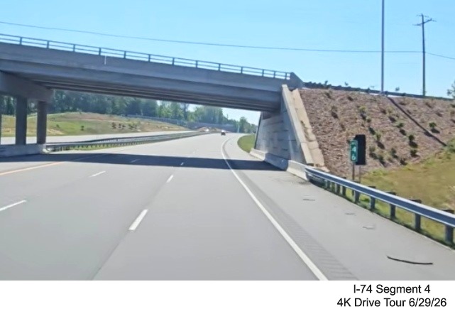Image of new I-74 mile 46 marker currently covered up next to NC 74 version
beyond the Baux Mountain Road 8 exit, screen grab from 4K Drive Tour video, June 29, 2026