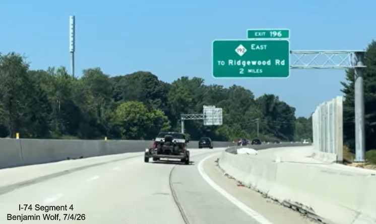 Image of new overhead 2 miles advance sign for NC 192 East, replacing the I-74 
	 East sign, at the end of the Winston-Salem Northern Beltway work zone on I-40 West, screen grab from Benjamin Wolf video, 
	 July 4, 2026