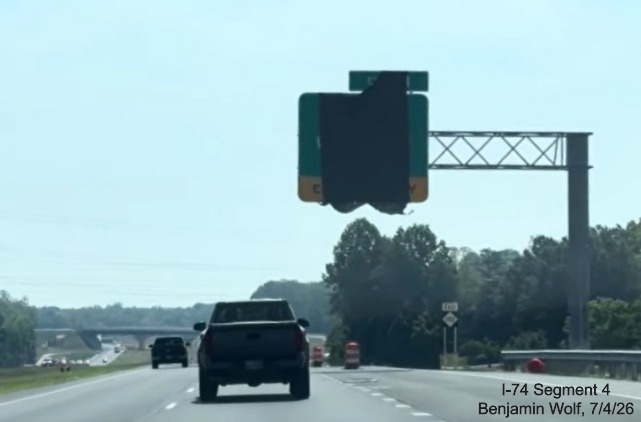 Image of overhead 1/2 mile advance sign for the future I-74 West
	 exit sign covered up, second East NC 192 ressurance marker in distance, screen grab from Benjamin Wolf video, July 4, 2026