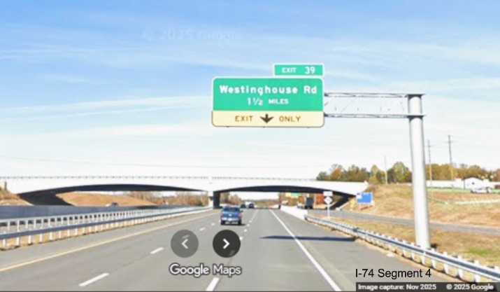 Image of renumbered 1 1/2 Miles advance overhead sign for the Westinghouse Road 
	  exit on US 52 North after the merge from the Winston-Salem Northern Beltway, Google Maps Street View, November 2025
