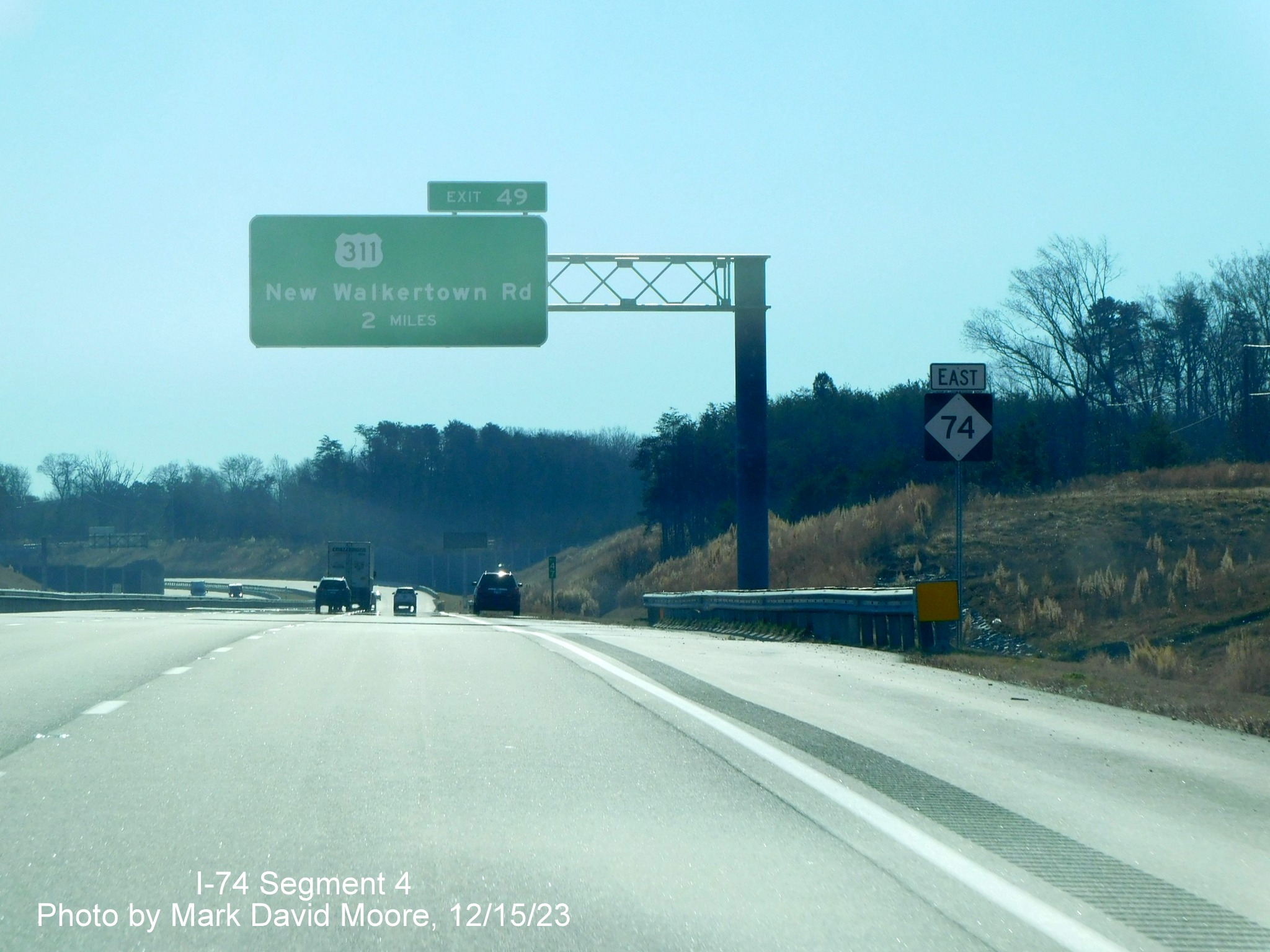 Image of East NC 74 reassurance marker following Baux Mountain Road exit prior to an
        overhead 2 Miles advance sign for the US 311 exit on NC 74 (Future I-74) East/Winston-Salem Northern Beltway, by Mark David Moore,         December 2023