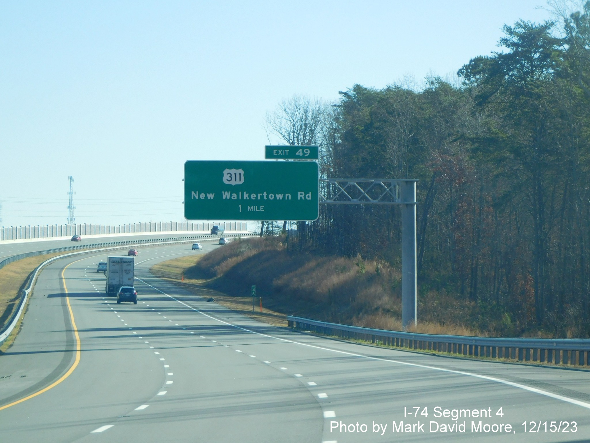 Image of the 1 Mile advance overhead sign for the US 311 exit on NC 74 (Future I-74) East/
        Winston-Salem Northern Beltway, there is a blank space next to the shield for a future West label, by Mark David Moore, December 2023