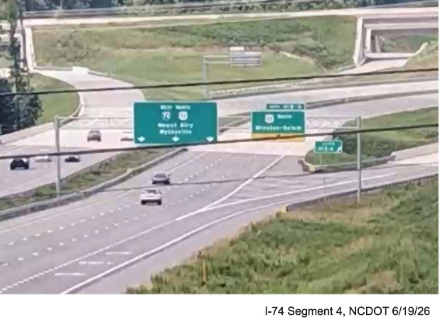 Traffic camera image of new West I-74/North US 52 overhead pullthrough
sign at the western end of the Beltway a seen from NC 66/University Parkway, June 2026