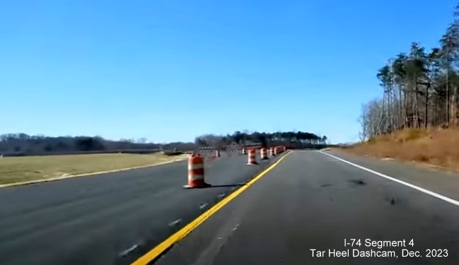 Image of of current NC 74 (Future I-74) traffic using future exit ramp to US 52 South, from video 
        by Tar Heel Dashcam, December 2023