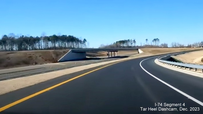Image of NC 74 (Future I-74) West traffic lanes from current US 52 North exit ramp, 
        from video by Tar Heel Dashcam, December 2023