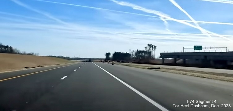 Image of NC 74 (Future I-74) East lanes using future westbound lanes after NC  65 bridge, from 
        video by Tar Heel Dashcam, December 2023
