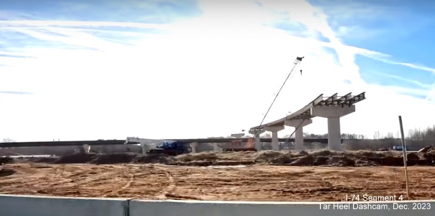 Image of flyover ramp construction for the NC 74/Winston-Salem Northern
        Beltway exit with I-40, from video by Tar Heel Dashcam, December 2023