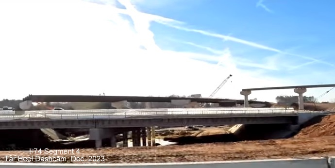 Image of flyover ramp construction for the NC 74/Winston-Salem Northern
        Beltway exit with I-40, from video by Tar Heel Dashcam, December 2023