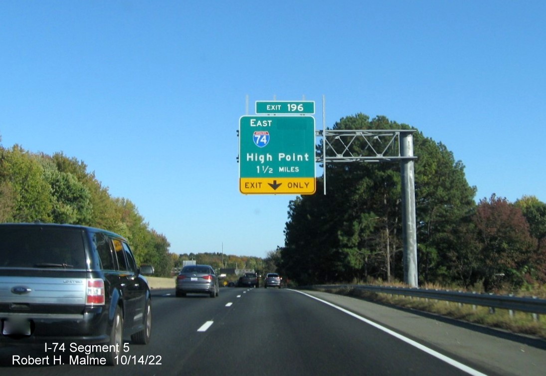 Image of 1 1/2 miles advance overhead sign for I-74 East exit on I-40 East in Winston-Salem with 
        dropped South US 311 information, October 2022