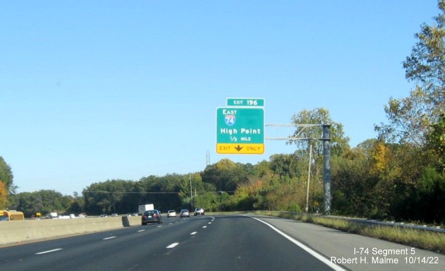 Image of 1/2 mile advance overhead sign for I-74 East exit on I-40 East in Winston-Salem with 
        dropped South US 311 information, October 2022