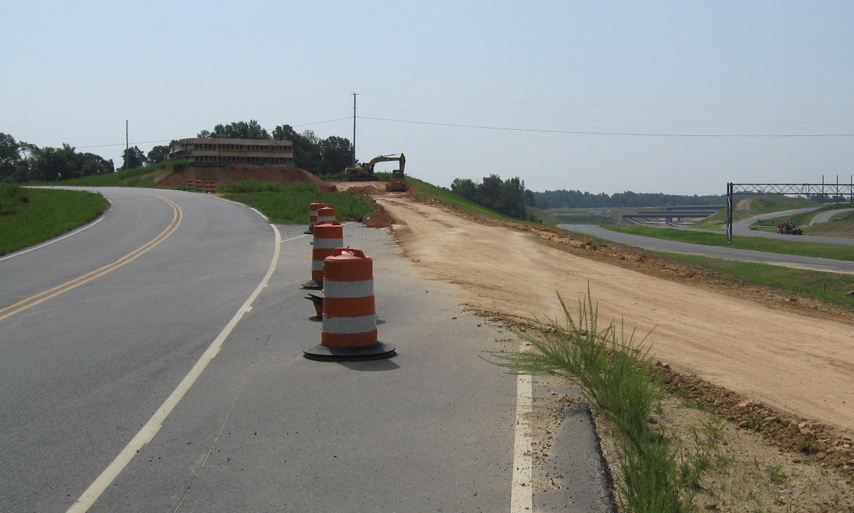Photo of construction materials to be moved using unopened I-74 freeway and 
access road in July 2010