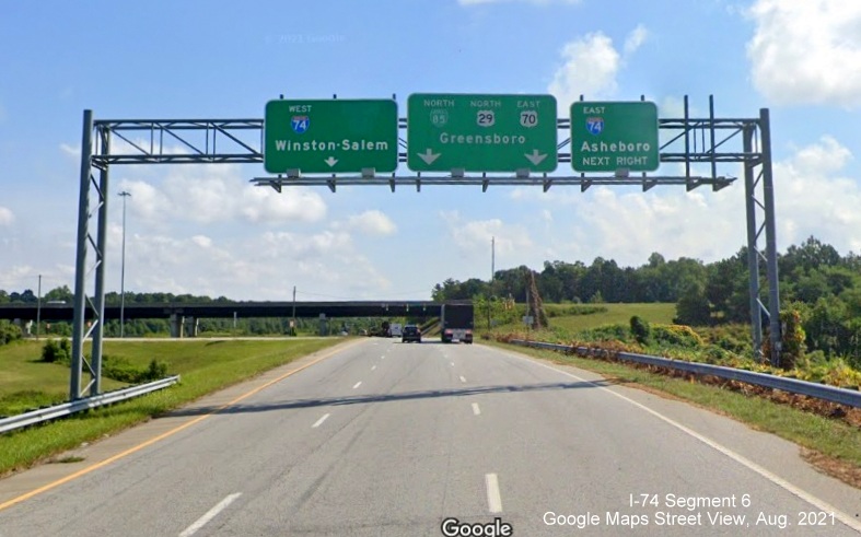 Overhead signage at Business 85 North interchange with I-74 with blank space for former US 311 
        signs, Google Maps Street View image, August 2021